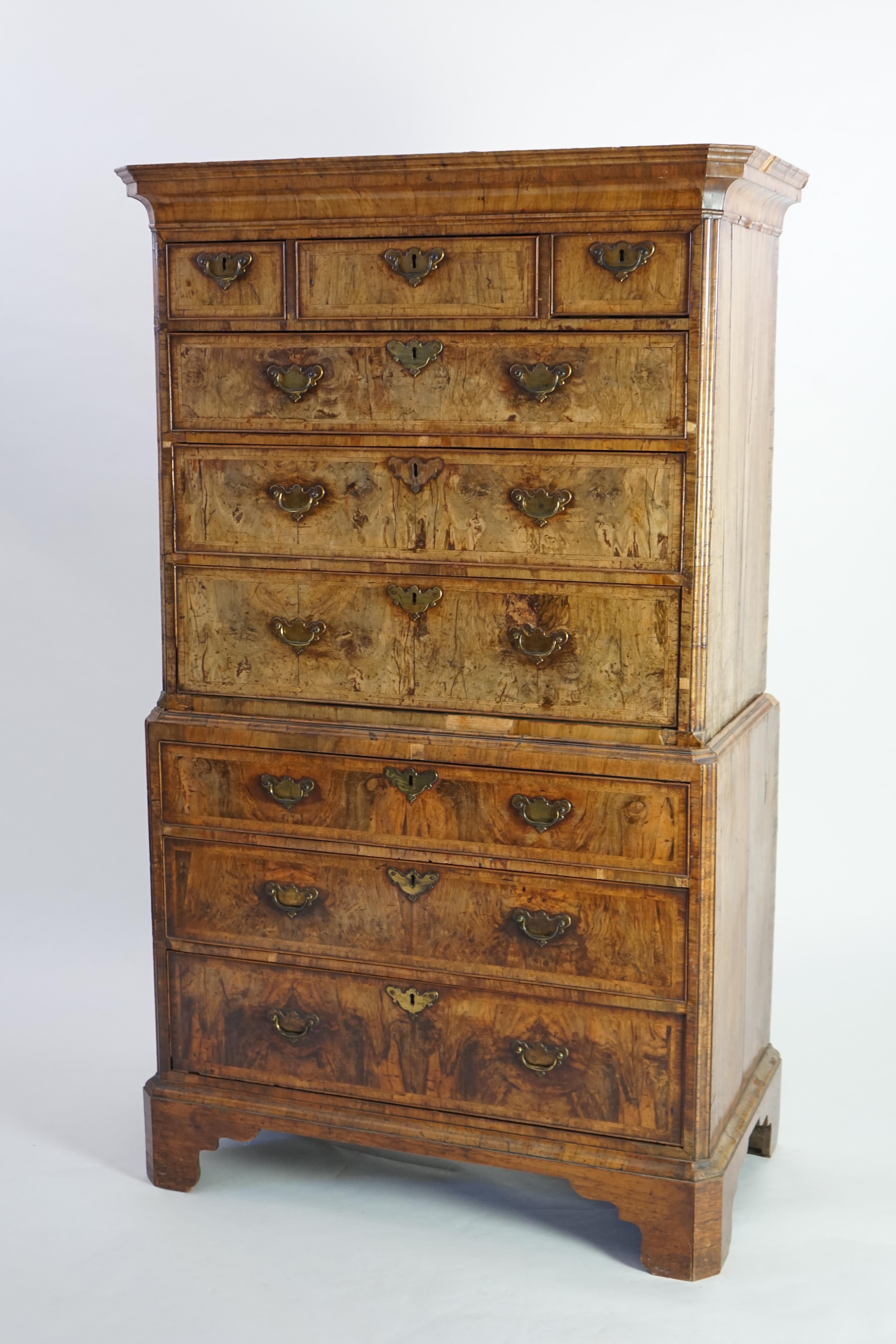 A George II feather banded walnut chest on chest